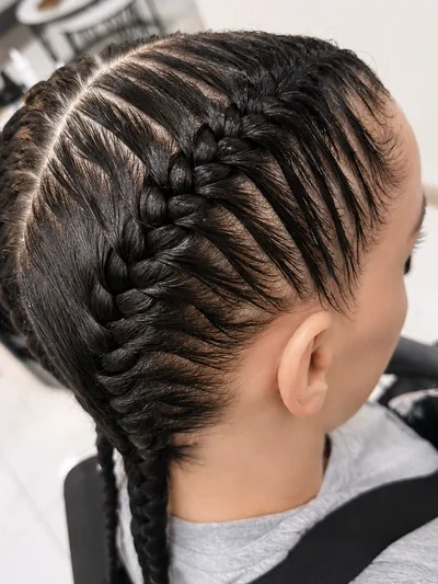 Two tight cornrow braids worked close to the scalp.