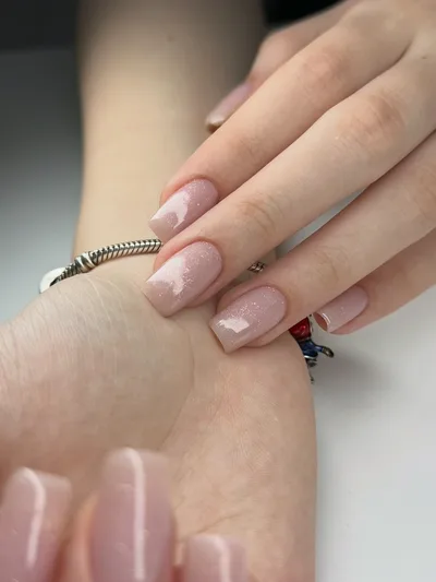 Long square nails in a soft pink shade with a fine shimmer.